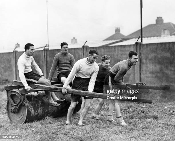 Robledo, Whyte, Pallister, Normanton and Kitchen lend a hand with the roller at Fleetwood F. C. Ground where Barnsley F. C. Are preparing for their...