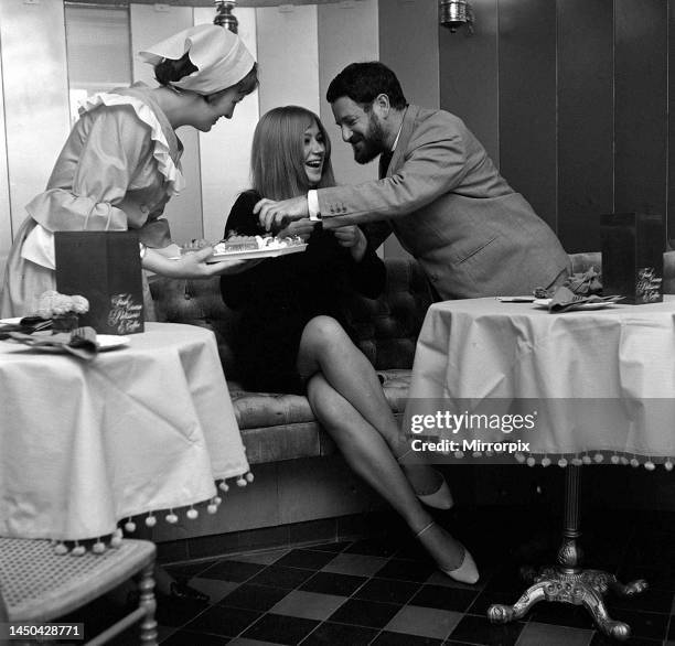 Actress Helen Mirren with artist Nicholas Egon in the Cartouche Restaurant. 5th October 1965.