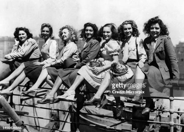 Some of the ENSA girls grouped on the ships rails on board the Empress of Scotland before disembarking. The girls are Mary Mason of Coventry, Katie O...