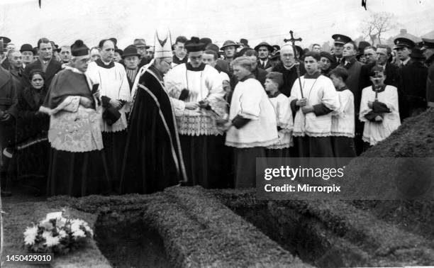 The Archbishop of Cardiff conducts a burial service for unidentified air raid victims.