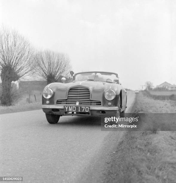Ronald Helterington from Birmingham seen here with Reg Pannell in his Aston Martin DB2 motor car traveling in excess of a 100 mphDecember 1954.