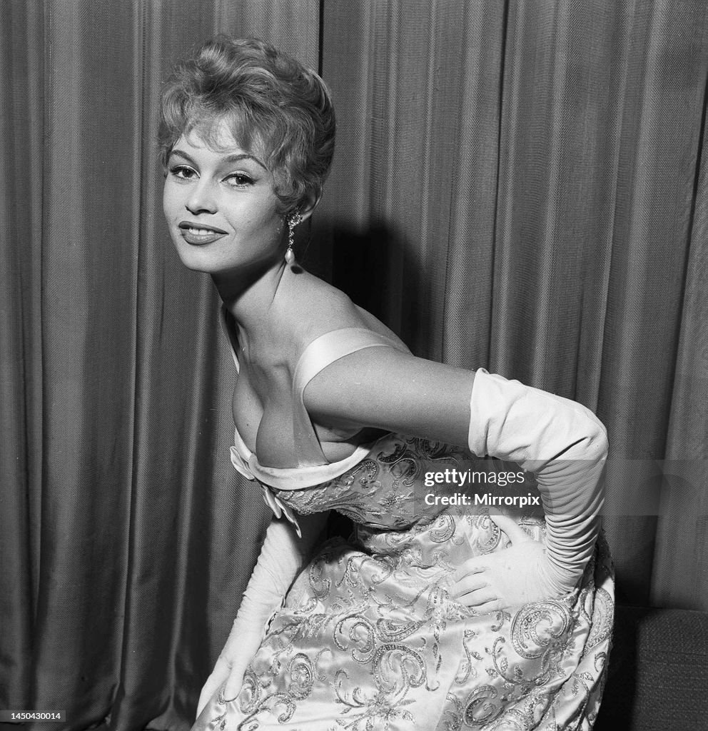 Bridgitte Bardot rehearses her curtsy in anticipation of her meeting with the queen October 1956