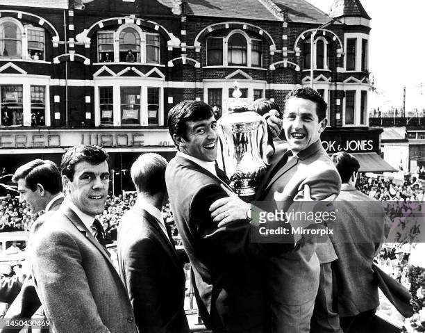 Tottenham Hotspur players L-R: Mike England, Frank Saul, Terry Venables and captain Dave Mackay display the FA Cup trophy en route to a civic...