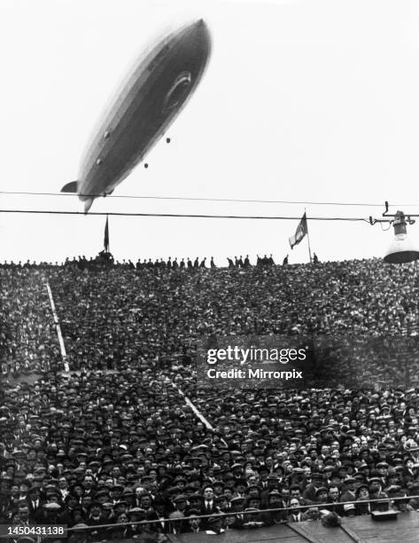 The Graf Zeppelin passing low over Wembley Stadium during the FA Cup Final in which Arsenal beat Huddersfield. The airship was booed by some of the...