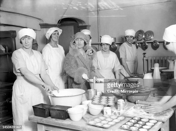 The Duchess of York helps with the preparation of a christmas pudding at Market Harborough December 1927.
