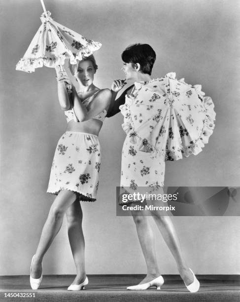 Two models wearing underwear and holding umbrellas. 23rd February 1967.