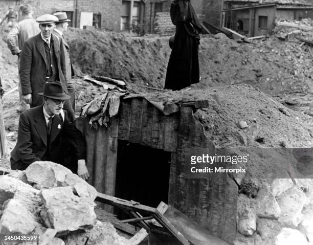 Pictured is the Anderson shelter which saved four people when a bomb made the crater in the background during the previous nights air raid over the...