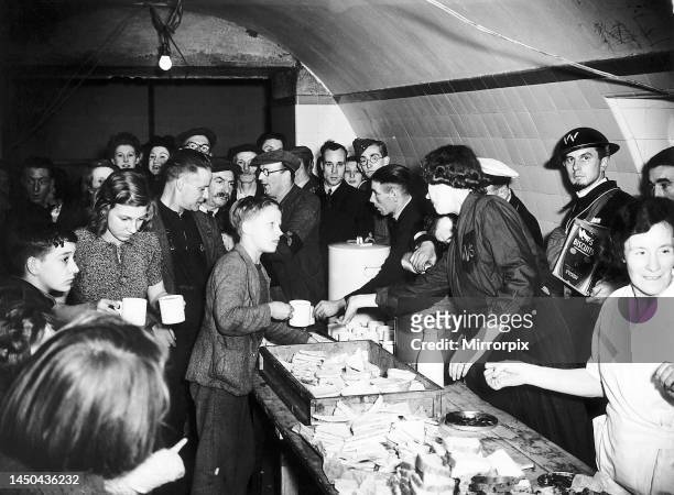 Womens Voluntary Service serve tea and sandwiches to people sheltering from German bombing raids at the Liverpool Street underground air raid...
