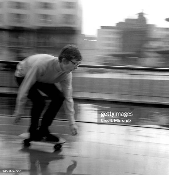 Music producer Andy Wickham rides on a Sidewalk surfer at Marble Arch, London which he brought from America. March 1965.