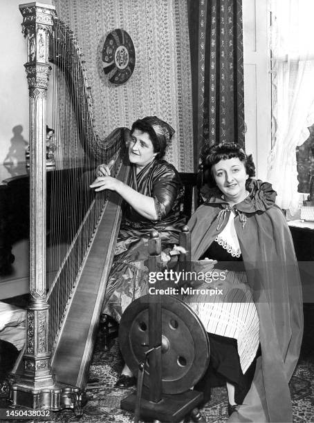 One lady playing the harp while her friend is spinning in April 1960.