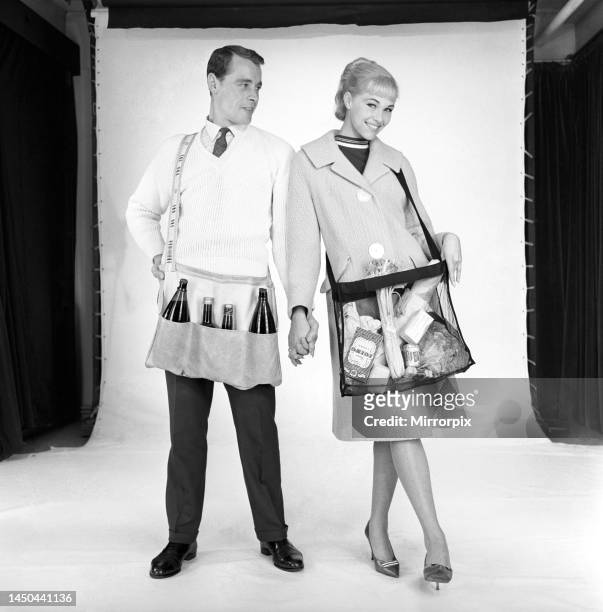 Man and woman wearing matching aprons. 1960.