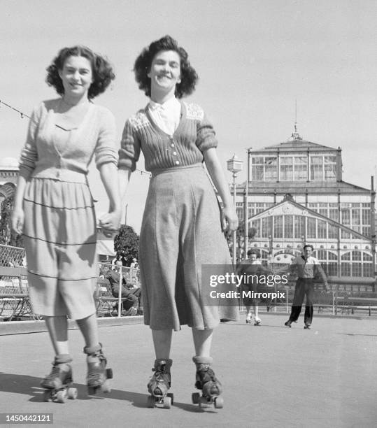 Friends rolling skating in the August sunshine at the Winter Gardens in Great Yarmouth 8th August 1949.