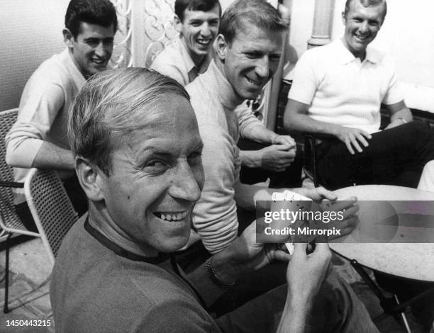 Bobby Charlton holds a full house in a game of cards with team mates Peter Bonetti, Martin Peters, Jack Charlton and Bobby Moore. 10th July 1966.