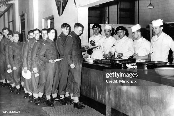 Men of the Royal Northumberland Fusiliers and the Royal Fusiliers lined up for their Christmas dinner at Fenham Barracks. This squad are having their...