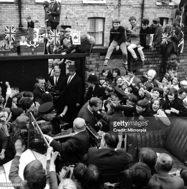 Jack and Bobby Charlton look over-awed as youngsters crowd around the car taking them to a civic reception in Ashington on 18th August 1966 after...