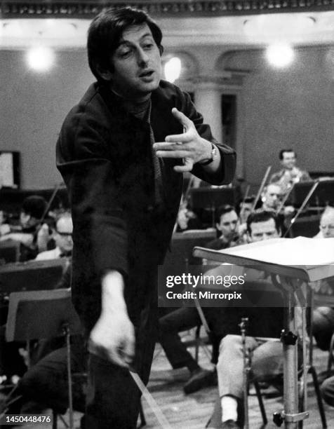 Pictures of conductor Andre Previn in action during a record session with the London Symphony Orchestra, at the Kingsway Hall. March 1969.