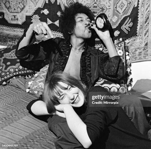 American singer and guitarist Jimi Hendrix with girlfriend Kathy Etchingham in his Mayfair flat, London. 7th January 1969.