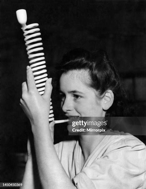 Miss Phylllis Bryan, one of the employees at the Broseley village factory, with an unusual spiral clay-pipe. Circa 1950.