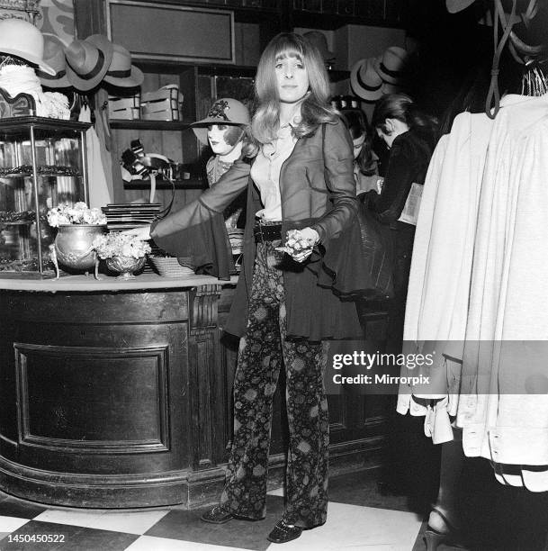 Boutique shop assistant Valerie Allen holding flowers in the BIBA shop. London. 28th March 1969.