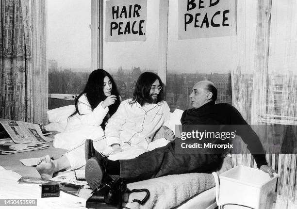 Pictured on their honeymoon bed newlyweds John Lennon and Yoko Ono talking to Donald Zec about their seven day Bed-In event at the Amsterdam Hilton...