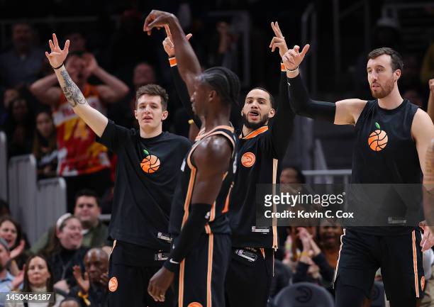 Vit Krejci, Tyrese Martin, and Frank Kaminsky of the Atlanta Hawks react after AJ Griffin hits a three-point basket to end the first quarter against...