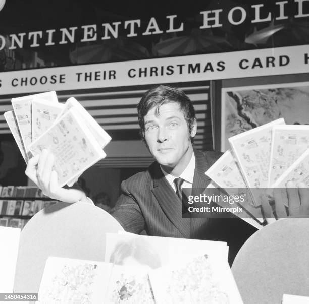 Roger Moore pictured at Pontings Department Store, Kensington, London, where he is helping to sell charity Christmas cards on behalf of the Variety...