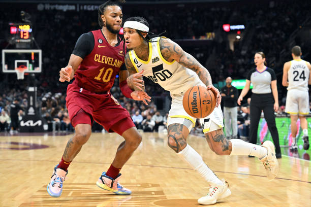 Jordan Clarkson of the Utah Jazz dribbles the ball to the basket around Darius Garland of the Cleveland Cavaliers during the third quarter at Rocket...