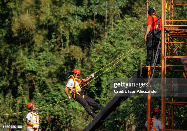 rescuer firefighter climbing with rope - rope high rescue stock pictures, royalty-free photos & images