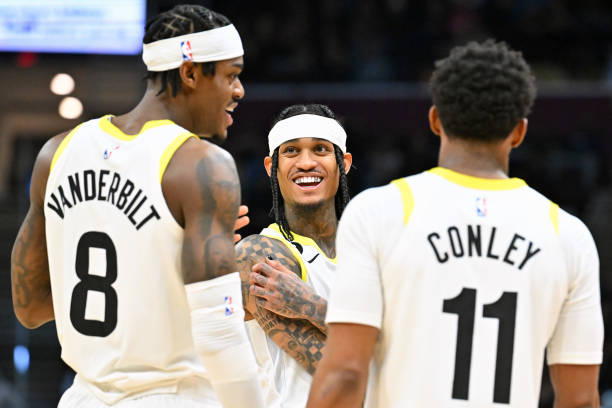 Jarred Vanderbilt, Jordan Clarkson and Mike Conley of the Utah Jazz talk during a timeout in the third quarter against the Cleveland Cavaliers at...