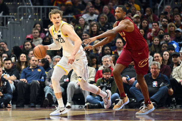 Lauri Markkanen of the Utah Jazz brings the ball up the court around Evan Mobley of the Cleveland Cavaliers during the third quarter at Rocket...