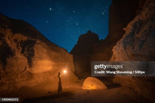 a woman camping in yadanli under the starry sky - image stock pictures, royalty-free photos & images