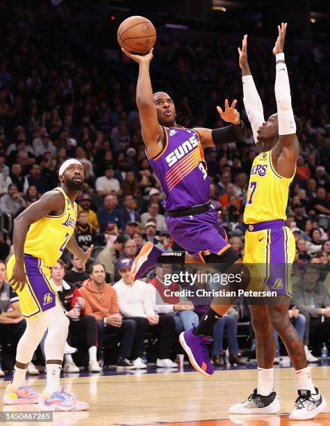 Chris Paul of the Phoenix Suns attempts a shot against Dennis Schroder of the Los Angeles Lakers during the first half of the NBA game at Footprint...