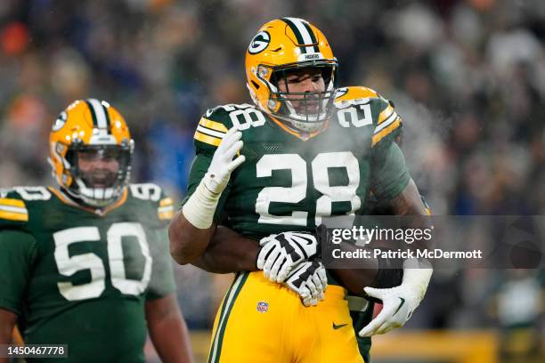 Dillon of the Green Bay Packers reacts after a touchdown against the Los Angeles Rams at Lambeau Field on December 19, 2022 in Green Bay, Wisconsin.