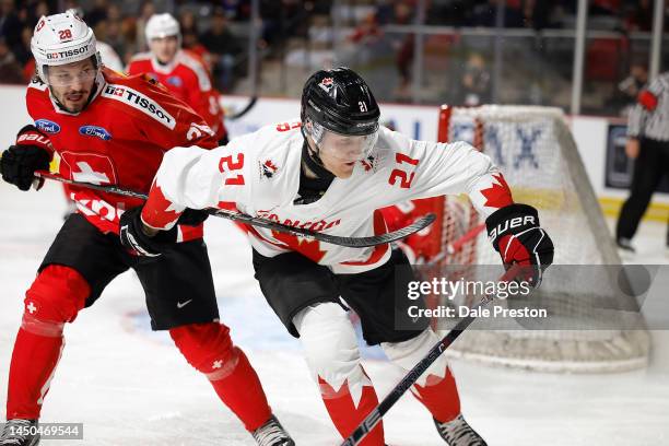 Nathan Gaucher of Team Canada gets hooked by Maximilan Streule of team Switzerland during second period of the 2023 IIHF World Junior Championship...