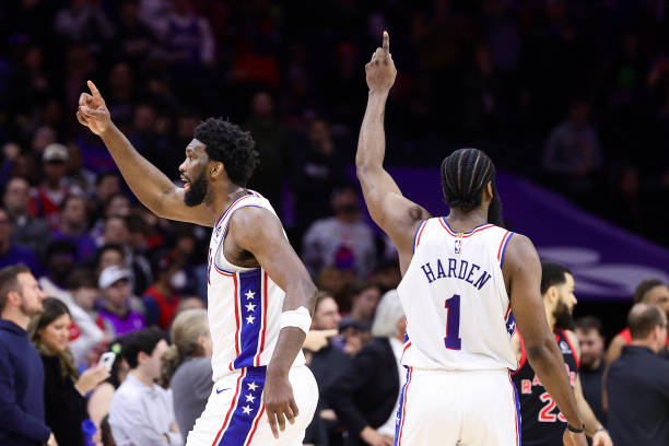 Joel Embiid and James Harden of the Philadelphia 76ers react during overtime against the Toronto Raptors at Wells Fargo Center on December 19, 2022...