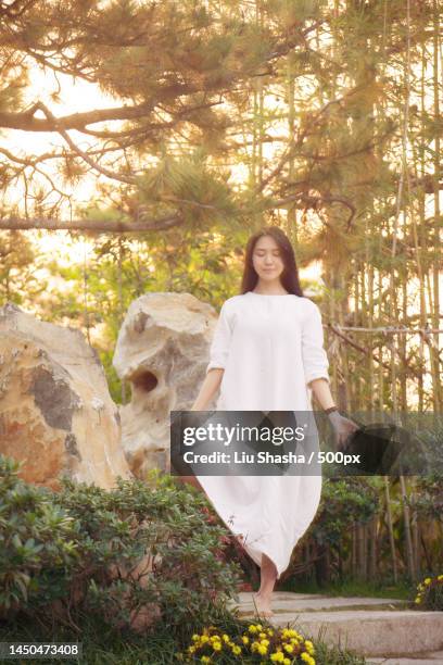 a girl doing yoga outdoors - image stock pictures, royalty-free photos & images