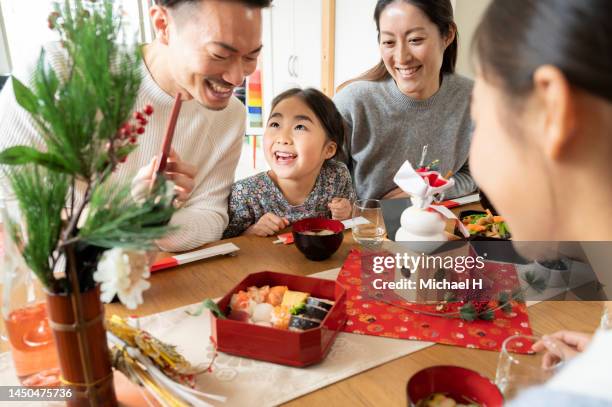 japanese family enjoying traditional new year dishes. - 御節料理 個照片及圖片檔