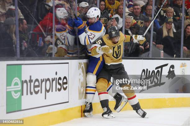 Keegan Kolesar of the Vegas Golden Knights hits Mattias Samuelsson of the Buffalo Sabres during the second period at T-Mobile Arena on December 19,...