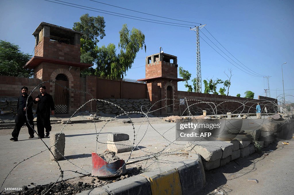 Pedestrians walk past the Peshawar centr