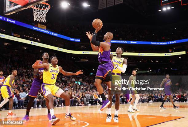 Chris Paul of the Phoenix Suns attempts a shot past Dennis Schroder of the Los Angeles Lakers during the first half of the NBA game at Footprint...