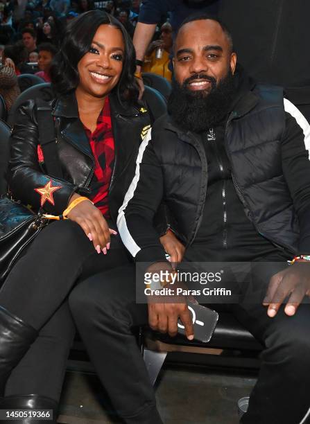 Kandi Burruss and Todd Tucker attend the game between the Orlando Magic and the Atlanta Hawks at State Farm Arena on December 19, 2022 in Atlanta,...