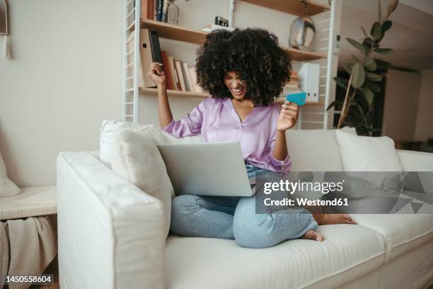 happy woman with credit card doing online shopping on laptop at home - online shopping bildbanksfoton och bilder