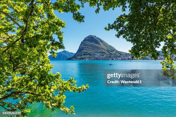 switzerland, ticino canton, lugano, view of lake lugano with monte san salvatore in background - ticino stockfoto's en -beelden