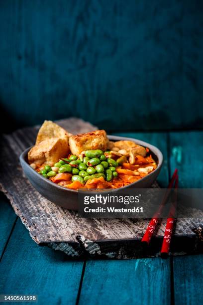 bowl of ready to eat vegan curry with edamame and tofu - thai food stock pictures, royalty-free photos & images
