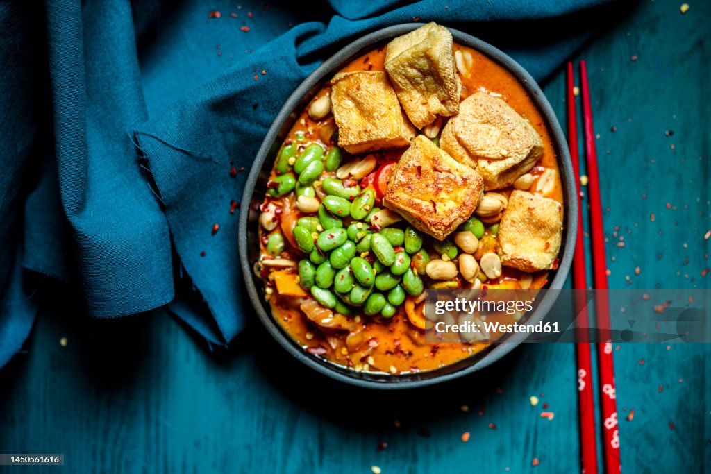 Bowl of ready to eat vegan curry with edamame and tofu