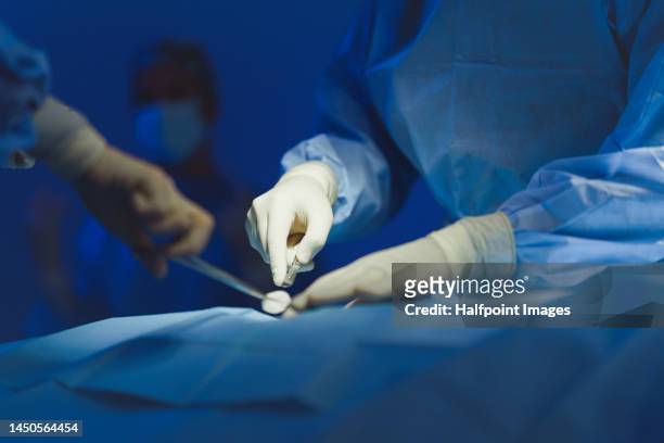 close-up of surgeon hands during operation. - scalpel stock pictures, royalty-free photos & images