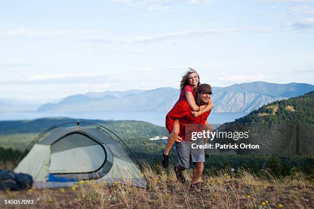 a happy couple smile and laugh on a backpacking and camping trip in idaho. - pend orielle lake stock pictures, royalty-free photos & images