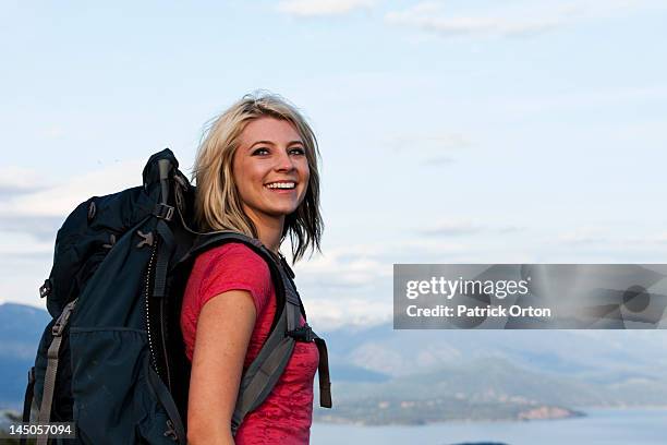a athletic woman smiling on a backpacking trip in idaho. - pend orielle lake stock pictures, royalty-free photos & images