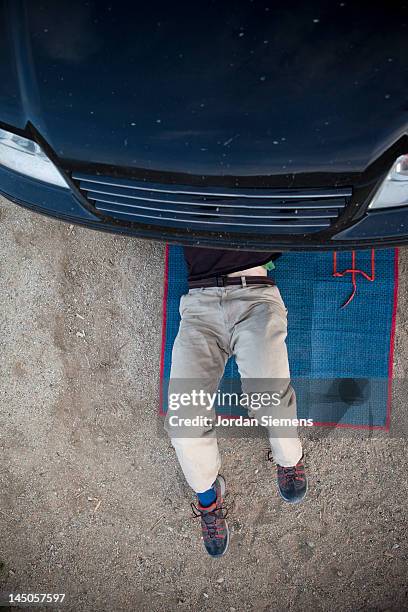 man fixing a car. - car mat stock pictures, royalty-free photos & images