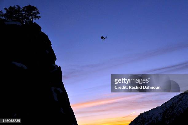 pro skier josh daiek performs a front flip at sunset while ski base jumping off of lovers leap in strawberry, ca. - base jumping stock pictures, royalty-free photos & images